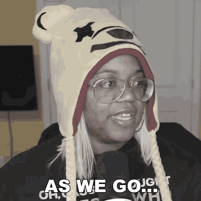 a woman wearing a winnie the pooh hat says as we go