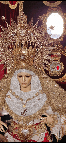 a statue of a woman with a crown on her head and a cross on her chest