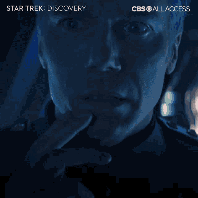 a cbs ad for star trek discovery shows a man looking out a window