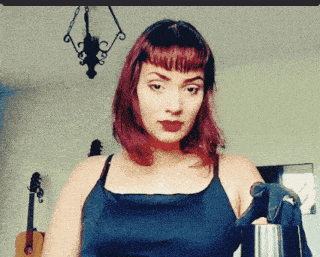 a woman with red hair is standing in front of a guitar and a clock