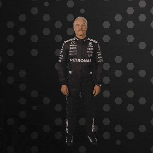 a man in a petronas racing suit is dancing