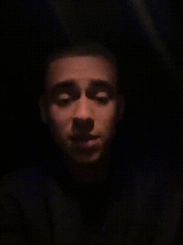 a man in a dark room with the word faz o l on the bottom left