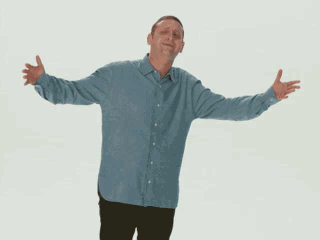 a man with his arms outstretched is standing in front of a sign that says really