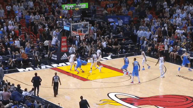 a basketball game is being played in front of a crowd with an ad for kia