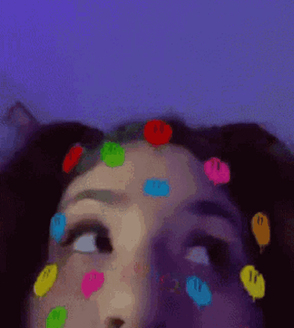 a close up of a woman 's face with smiley faces on it
