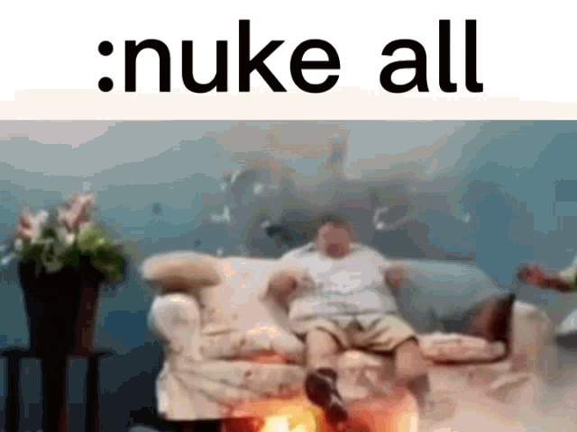 a picture of a man sitting on a couch with the words nuke all above him