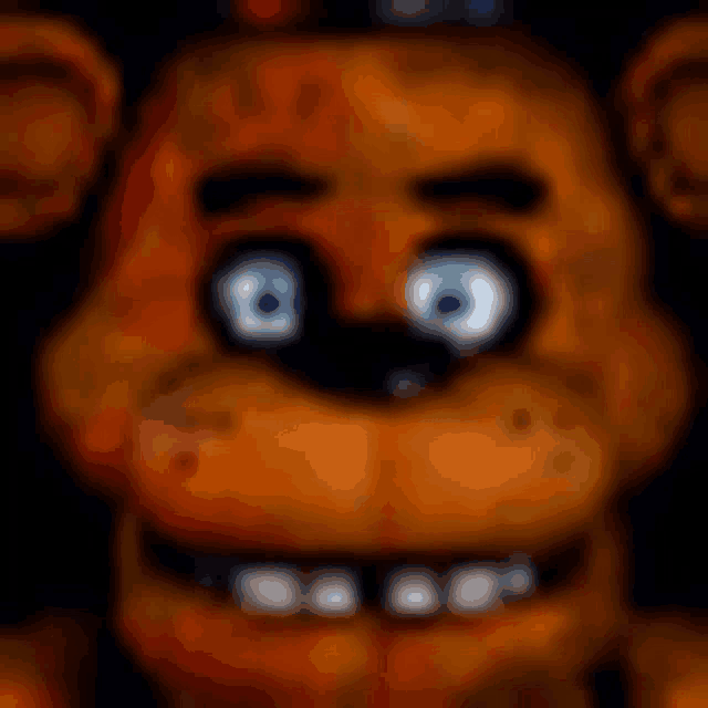 a close up of the face of a teddy bear with blue eyes .