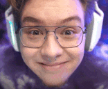 a close up of a man wearing glasses and headphones making a funny face .