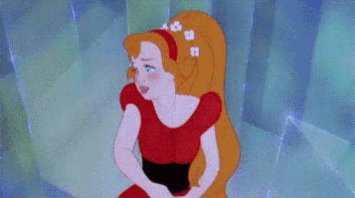 a woman in a red dress is holding her stomach
