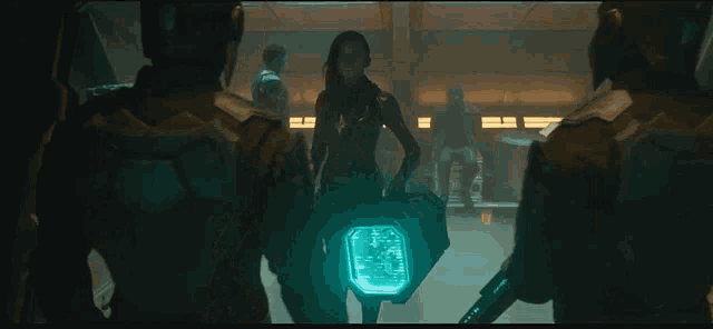 a woman with red hair is standing in a dark room with a man in a green suit behind her .