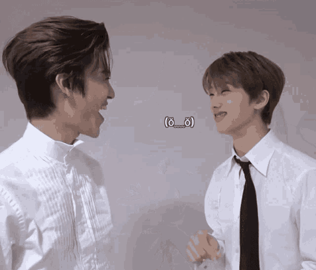 two men in white shirts and ties are laughing and looking at each other ..