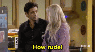 a man and a woman are standing in a kitchen and the woman says how rude .