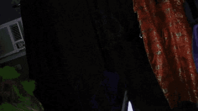 a drag queen is wearing a purple robe and a white wig