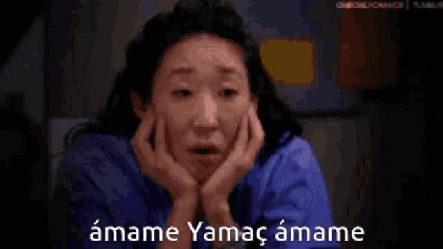 a woman with her hands on her face and the words amame yamac amame below her