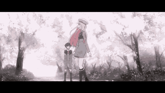 a girl and a boy are standing next to each other in the woods .