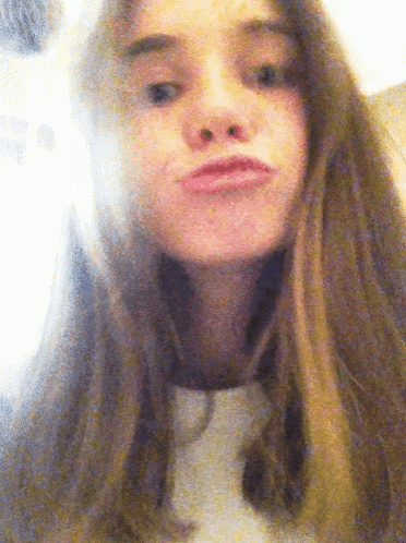 a girl with long hair making a funny face with her mouth open
