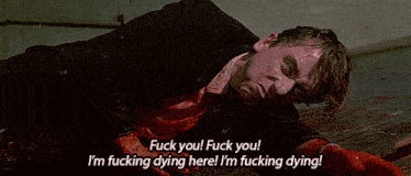 a man is laying on the floor and says " fuck you "