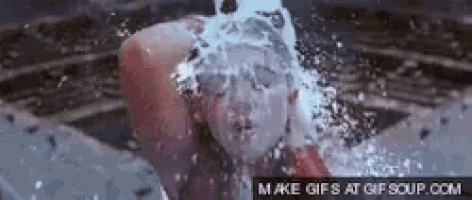 a woman is being splashed with water and the words make gifs at gifsoup.com can be seen in the corner