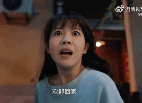 a woman in a blue shirt with chinese writing on her shirt