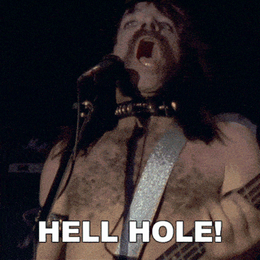 a shirtless man singing into a microphone and playing a guitar with the words hell hole below him