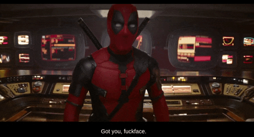deadpool is standing in front of a control room and says got you fuckface