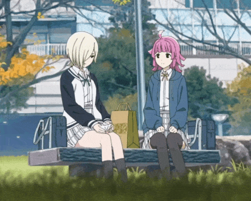 two anime girls are sitting on a bench with a brown bag