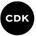 a black circle with the word cdk written in white letters .