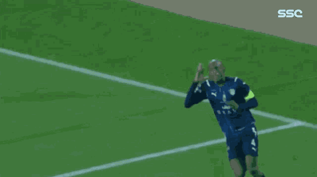 soccer players are celebrating a goal on a field with the ssc logo in the corner