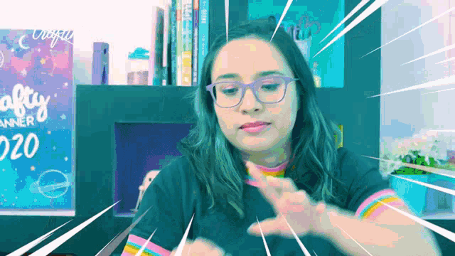 a woman wearing glasses is in front of a crafty planner