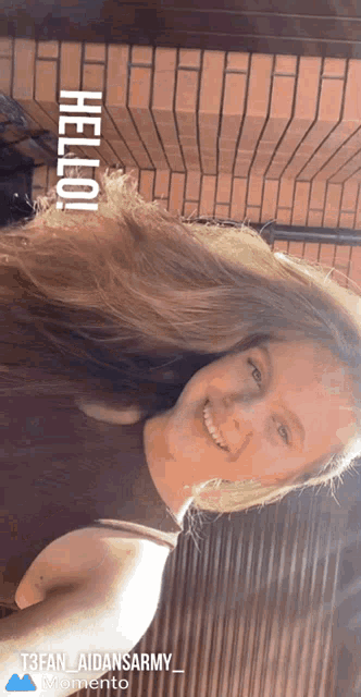 a woman with long hair is smiling with the words hello written above her