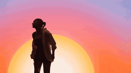 a silhouette of a woman standing in front of the sun