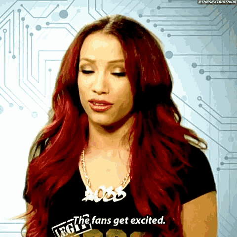 a woman with red hair is wearing a shirt that says " the fans get excited "