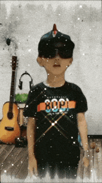 a young boy wearing sunglasses and a black shirt with the number 80 on it