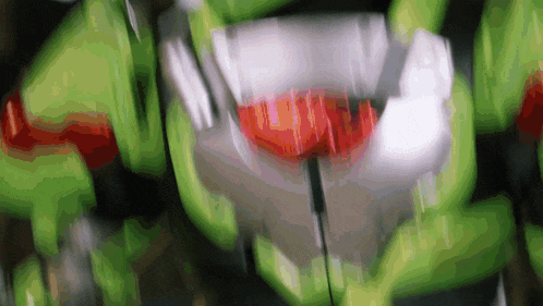 a blurred image of a green and white object with a red heart