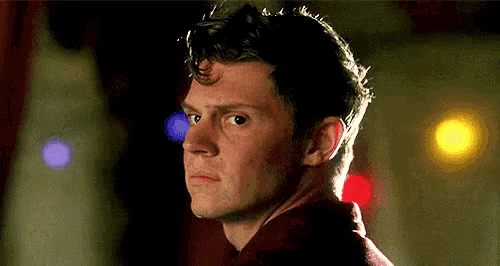 a close up of a man 's face with a blurred background of lights