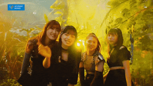 a group of young women are posing for a picture in front of a sign that says upfront works