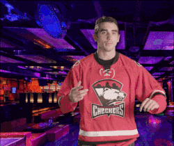 a man wearing a red checkers jersey is dancing