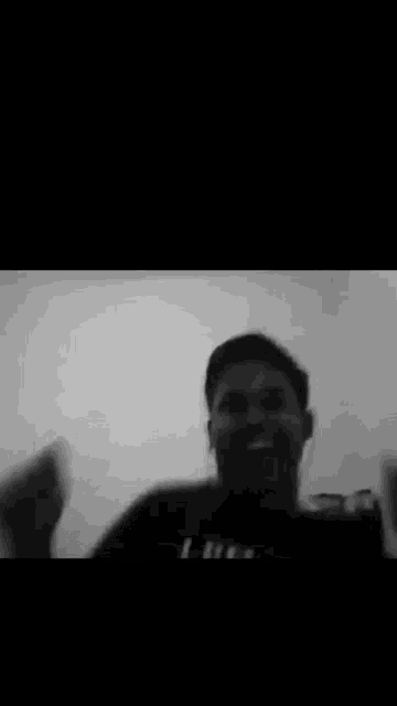a blurry black and white photo of a man with a mask on his face .