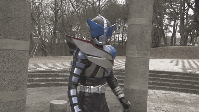 a person in a superhero costume is standing in front of a staircase