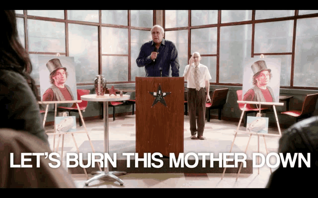 a man stands at a podium with the words let 's burn this mother down on the bottom
