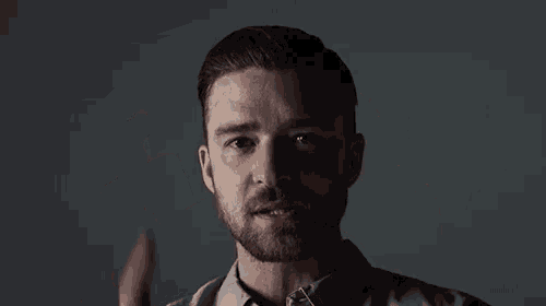 a man with a beard is making a hand gesture