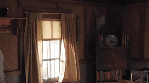a room with a window and a shelf with a plate on it that says ' home '