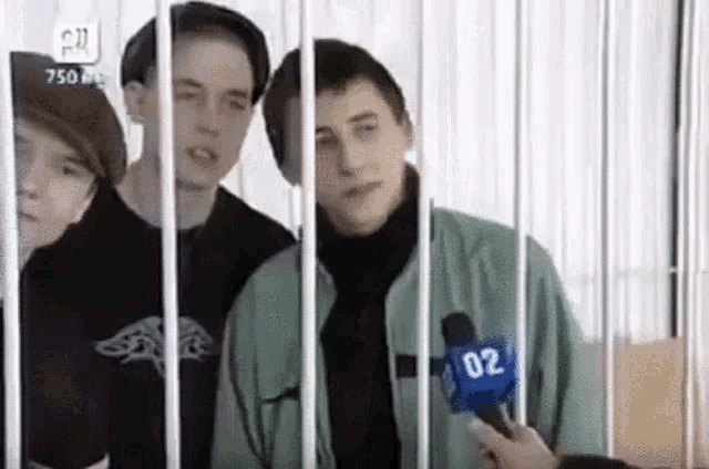 a man behind bars with the number 02 on his microphone