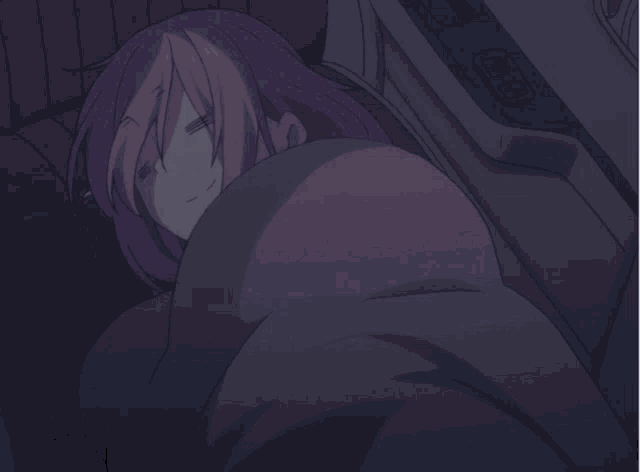 a girl with pink hair is sleeping in a blanket