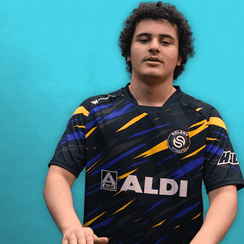 a man wearing a black and blue shirt that says aldi on the front