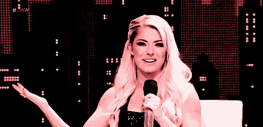 a woman is holding a microphone in front of a screen that says raw on it