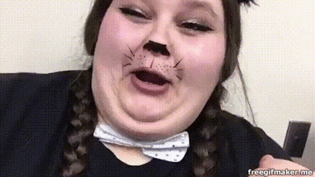 a woman with a cat face painted on her face is making a funny face