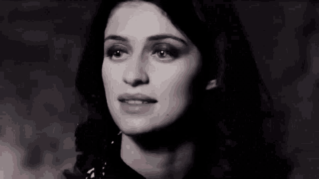 a close up of a woman 's face with a serious look on her face .