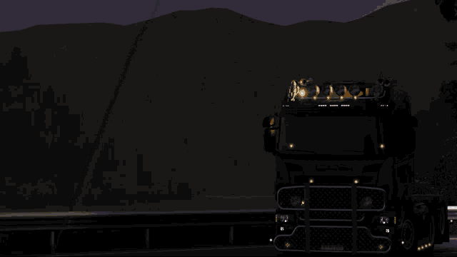a scania truck is driving down a road at night with the words good night above it
