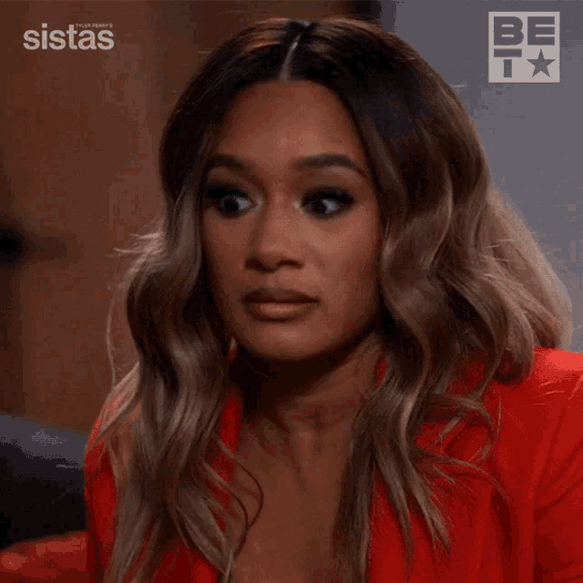 a woman in a red jacket says exactly in front of a sistas logo